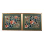 A pair of Chinese silk embroidered panels, decorated with flowers & stylised butterflies, framed &