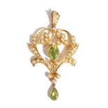 An Edwardian peridot & seed pearl pendant, the openwork pendant set with a central oval peridot with