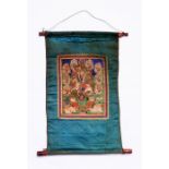A 19th century Tibetan thangka with central deity on horseback surrounded by further smaller