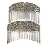 A pair of white metal hair slides, engraved with flowers and foliate scrolls, 8.5cm by 5.5cms.