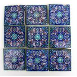 A group of Persian Iznik tiles, decorated with flowers on a blue ground, 13cms (5ins) square (9).