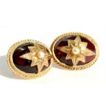A pair of yellow metal mounted oval garnet cabochon earrings set with a single pearl.