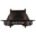 A Chinese hongmu pierced and carved wall shelf, 71cm wide by 42cm high (28ins by 16.5ins).