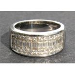 An 18ct white gold diamond ring, a central row of graduated baguette cut diamonds within two rows of