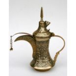 An Arab Islamic brass Dallah coffee pot, decorated with flowers, 30cms high.