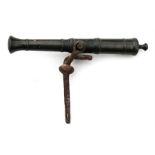 A 19th century bronze signal canon with iron spike mount 26cm (10.25ins) long.