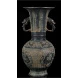 A Chinese bronze two-handled vase, decorated with stylised birds and gilded highlights, 29cms (11.