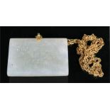 A Chinese jade rectangular belt buckle carved with a bird and prunus, on a long yellow metal