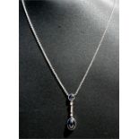 A white gold cabouchon sapphire and diamond set drop pendant necklace, the sapphire approximately