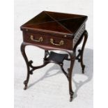 A Victorian mahogany envelope card table with fretwork decoration to sides, on carved cabriole legs,