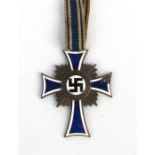 A German WWII Mothers Cross 'Mutterehrenkreuz' bronze class medal Condition Report some loss to
