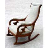 A walnut rocking chair with upholstered seat and back.