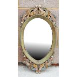 A carved and painted wooden framed mirror, 41cm (16ins) wide.