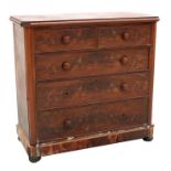 A Victorian figured mahogany chest of two short and three long graduated drawers, standing on bun