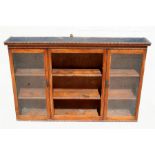 An oak wall mounted bookcase with two glazed doors, 147cm (58ins) wide (a/f).