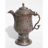 A large Middle Eastern tinned copper dallah type coffee pot, decorated with flowers and calligraphy,