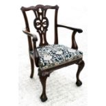 A walnut open armed gentleman's carver chair with carved and pierced back splat and upholstered