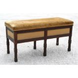 An Edwardian mahogany duet piano stool, the upholstered lift-up top enclosing a sectioned