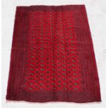 A Turkoman rug decorated with a repeat design within a stylised border, on red ground, 190cms by