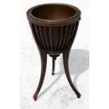 An Edwardian mahogany jardiniere stand.