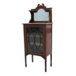 An Edwardian mahogany mirror back display cabinet, the single glazed door enclosing two shelves,