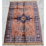 A machine made Belgium silk effect rug with three central medallions within a geometric border on