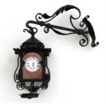 A Victorian lantern wall clock, the white enamel dial having Roman numerals and named 'Campbell,