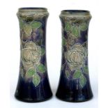 A pair of Doulton stoneware vases, tubeline decorated with roses 26cm (10.25ins) high.