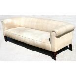 A late 19th century Chesterfield sofa, on mahogany turned front legs, 191cm (75ins) wide.