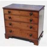 An early 19th century mahogany chest of four long graduated drawers, standing on bracket feet,