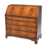 A Georgian figured mahogany bureau, the fall front enclosing a combination of drawers, pigeon