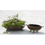 A cast iron oval garden planter and a similar smaller (2).