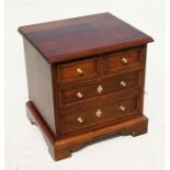 A modern mahogany miniature chest of two short and two long drawers, 46cm (18ins) wide.