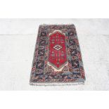 A Turkish rug, 118cm by 190cm (46.5 by 74.75 ins)