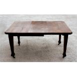 An early 20th century oak extending dining table with one extra leaf and winding handle, 146 by