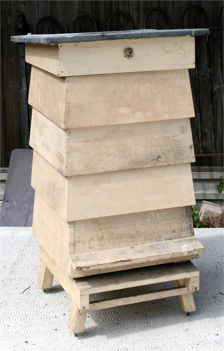 A four-tier painted wooden beehive, 65cms wide.