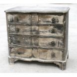 A pine serpentine fronted chest of four long graduated drawers with textured silvered gesso