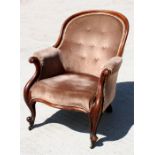 A Victorian mahogany button back armchair.