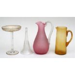 A 19th century pink crackle glass jug, an amber glass jug, a tall glass comport and an etched