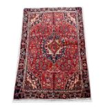 A Bakhtairi woollen handmade rug with central medallion within a foliate border, on beige ground,