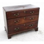 An early 19th century mahogany chest with three graduated long drawers, standing on bracket feet (