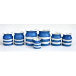 A group of seven graduated T. G. Green Cornishware storage jars and lids, with green shield back