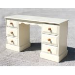 A modern painted pine dressing chest with six short drawers, 137cm (54ins) wide.