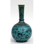 A Middle Eastern blue underglazed pottery vase, decorated with flowers and foliate scrolls on a