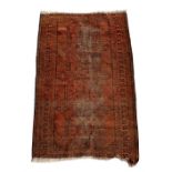 A Persian rug, with four central medallions on a burnt orange ground 89cms by 135cms (35ins by