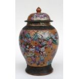 A Chinese crackle glazed vase and cover, decorated with figures in enamel colours, with impressed