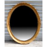 An oval gilt framed wall mirror, 70 by 85cm (27.5 by 33.5ins).