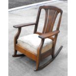 An early 20th century oak rocking chair.