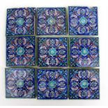 A group of Persian Iznik tiles, decorated with flowers on a blue ground, 13cms (5.2ins) square (9).