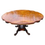 A Victorian burr walnut loo table on four barley twist columns standing on a quatrofoil base,